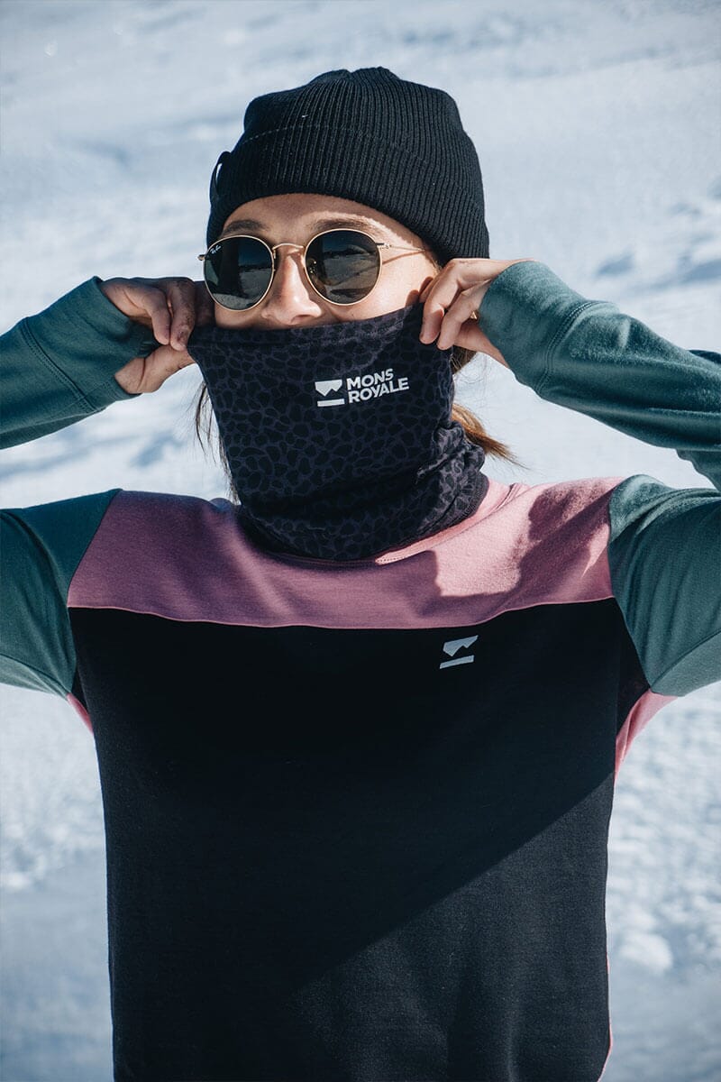 Women wearing Merino top, pulling balaclava over her face